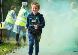 young-boy-running-through-coloured-powder