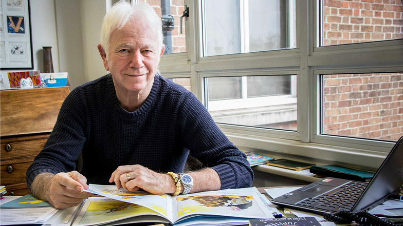 Tony Ross sits at his desk working on a book.jpg