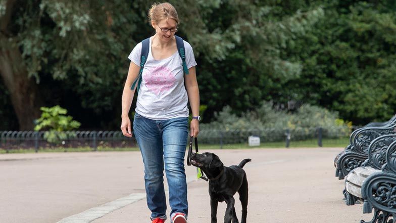 Bella and Puppy Walker Vicky walking along the path together Bella and Puppy Walker Vicky walking along the path together