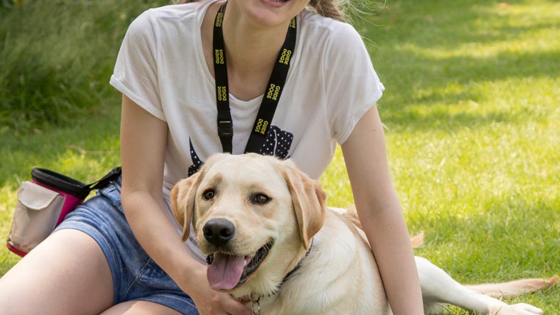 Guide Dogs trainer Abigail and Irvine having a cuddle in the park Guide Dogs trainer Abigail and Irvine having a cuddle in the park