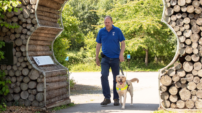 Poppy guiding her trainer David Poppy guiding her trainer David