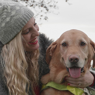 Guide dog owner Stacey with her arm around guide dog Toffee