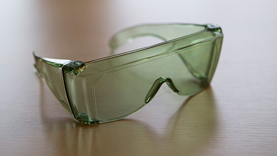 A pair of green fit over anti-glare shields on a table
