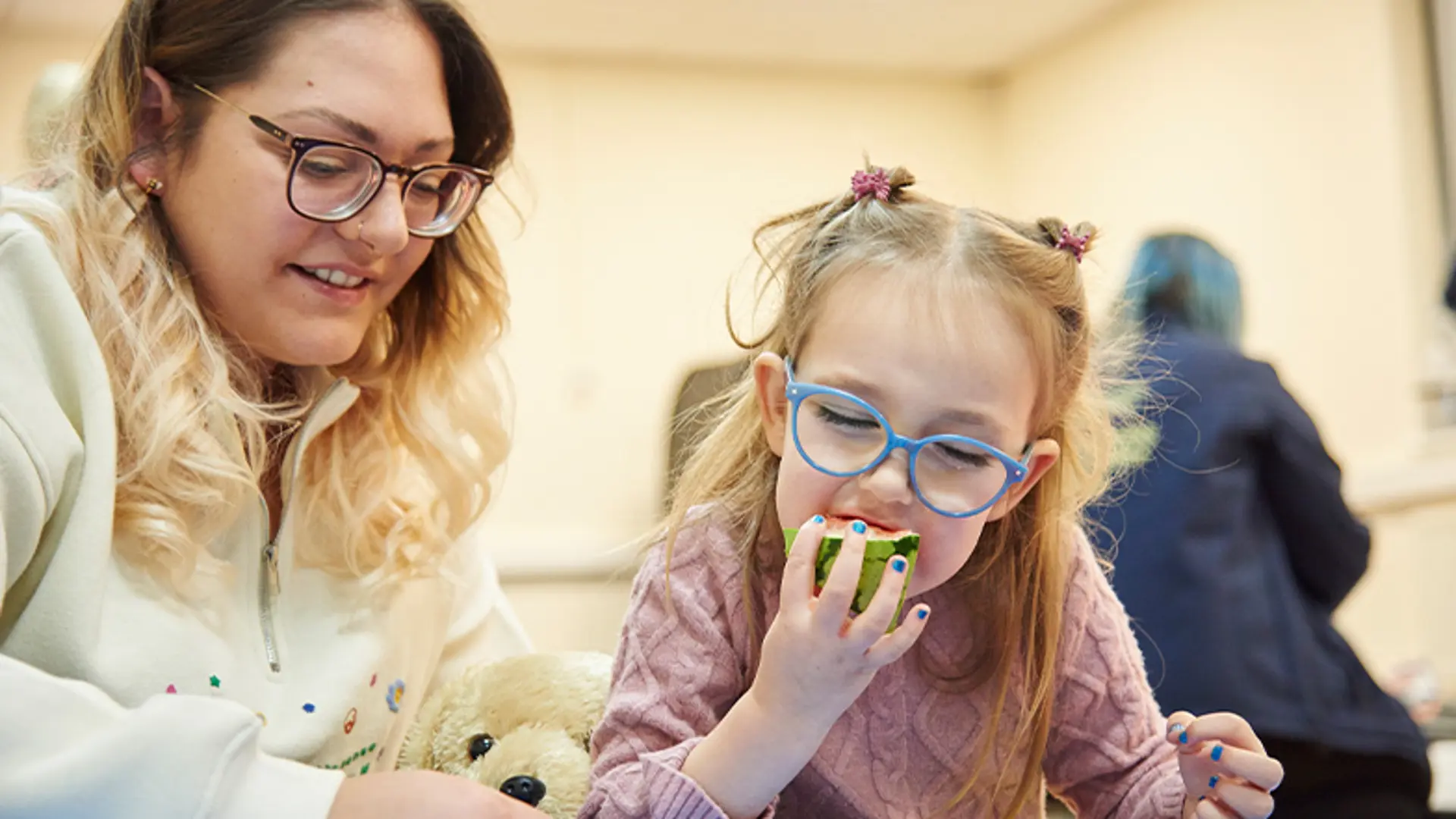 Ruby eating watermelon with her mum during a My Time to Play session