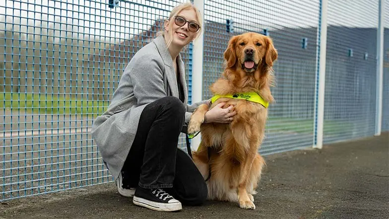 Hannah and Morris together looking at camera. Morris has his paw over Hannah's arm.