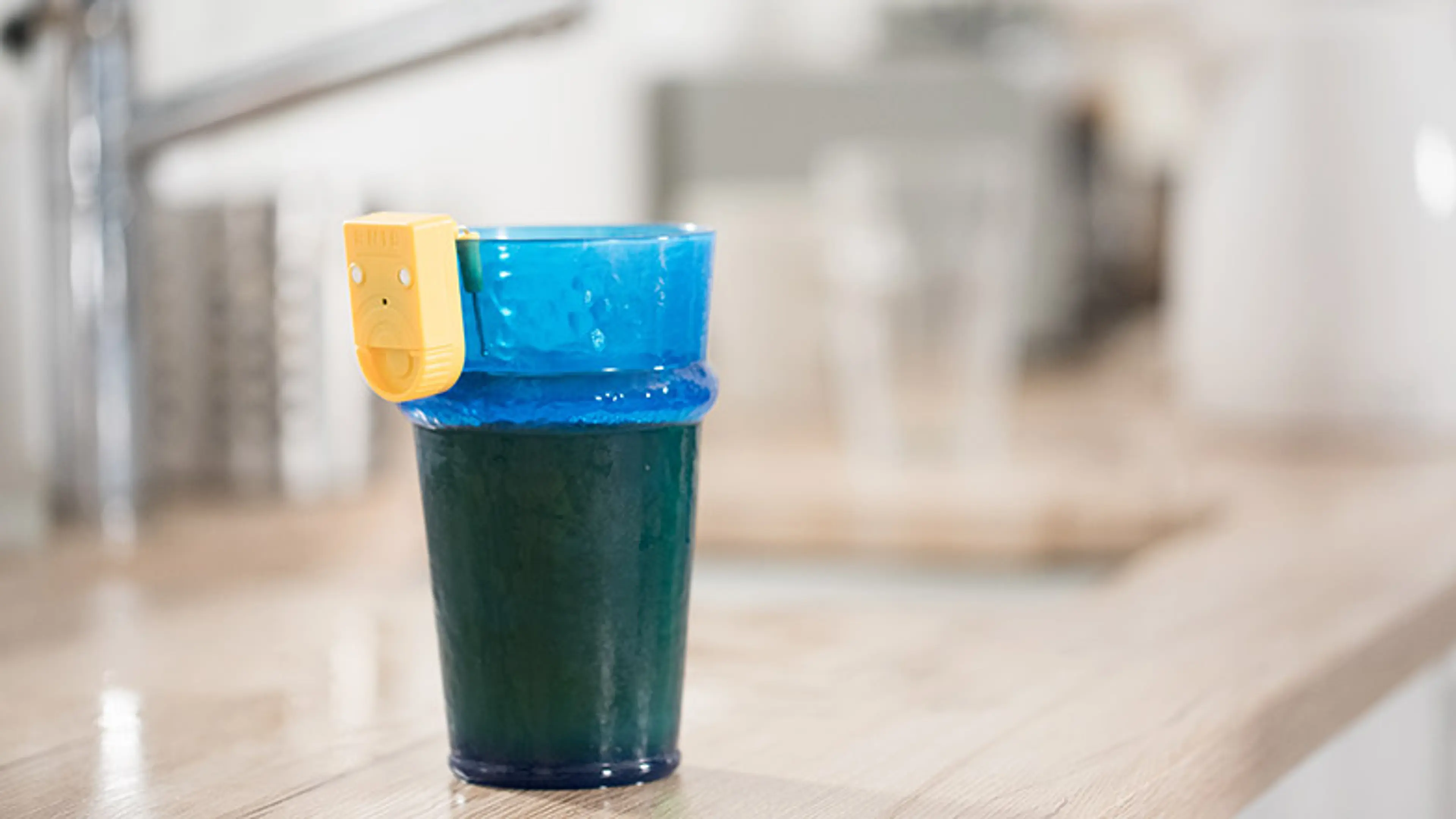 A picture of a blue glass with a liquid indicator attached to it. 
