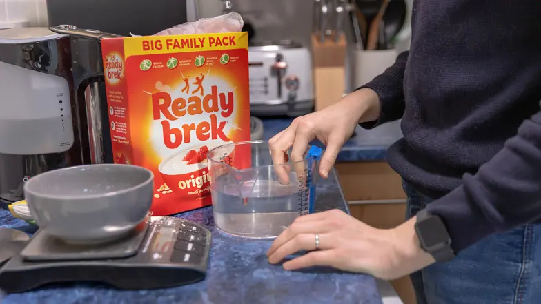 A man with sight loss using a talking kitchen scale