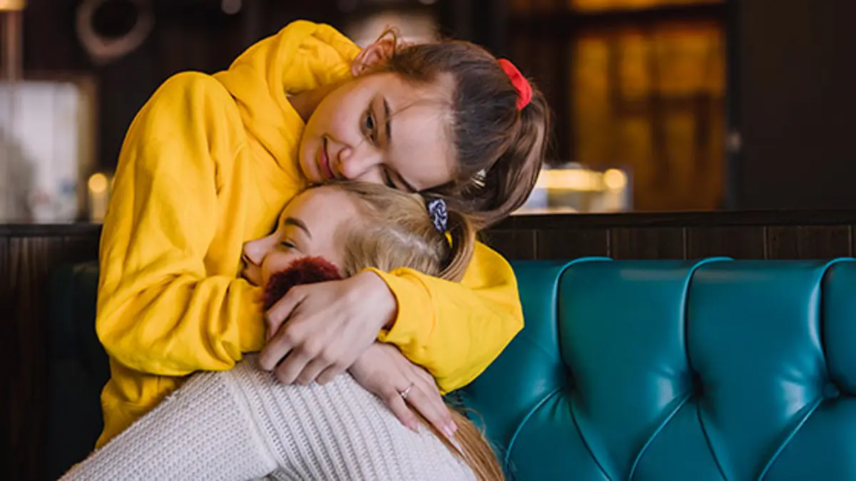 Young girl hugging her sister