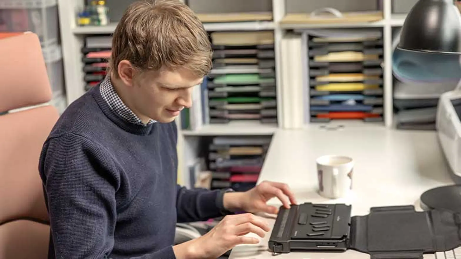 Callum using his Humanware Brailliant Braille display machine.