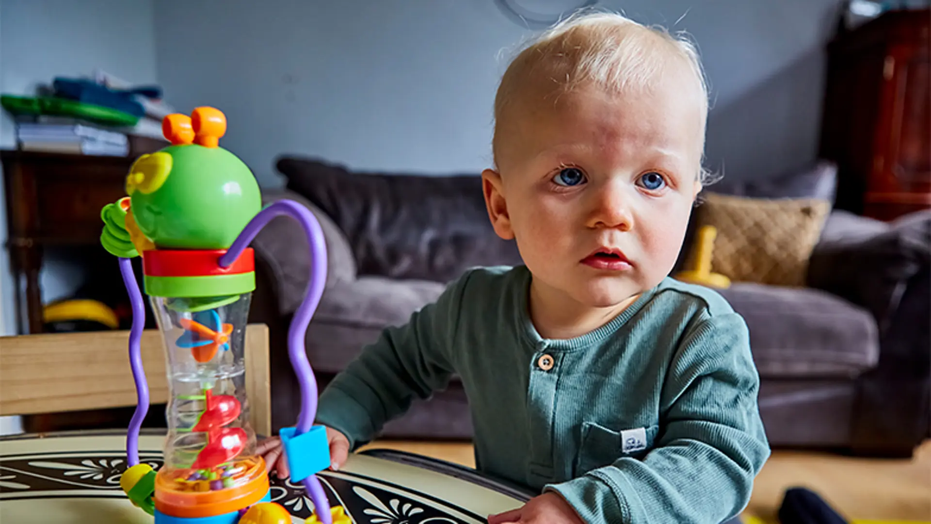 A young boy with a visual impairment playing with a sensory toy
