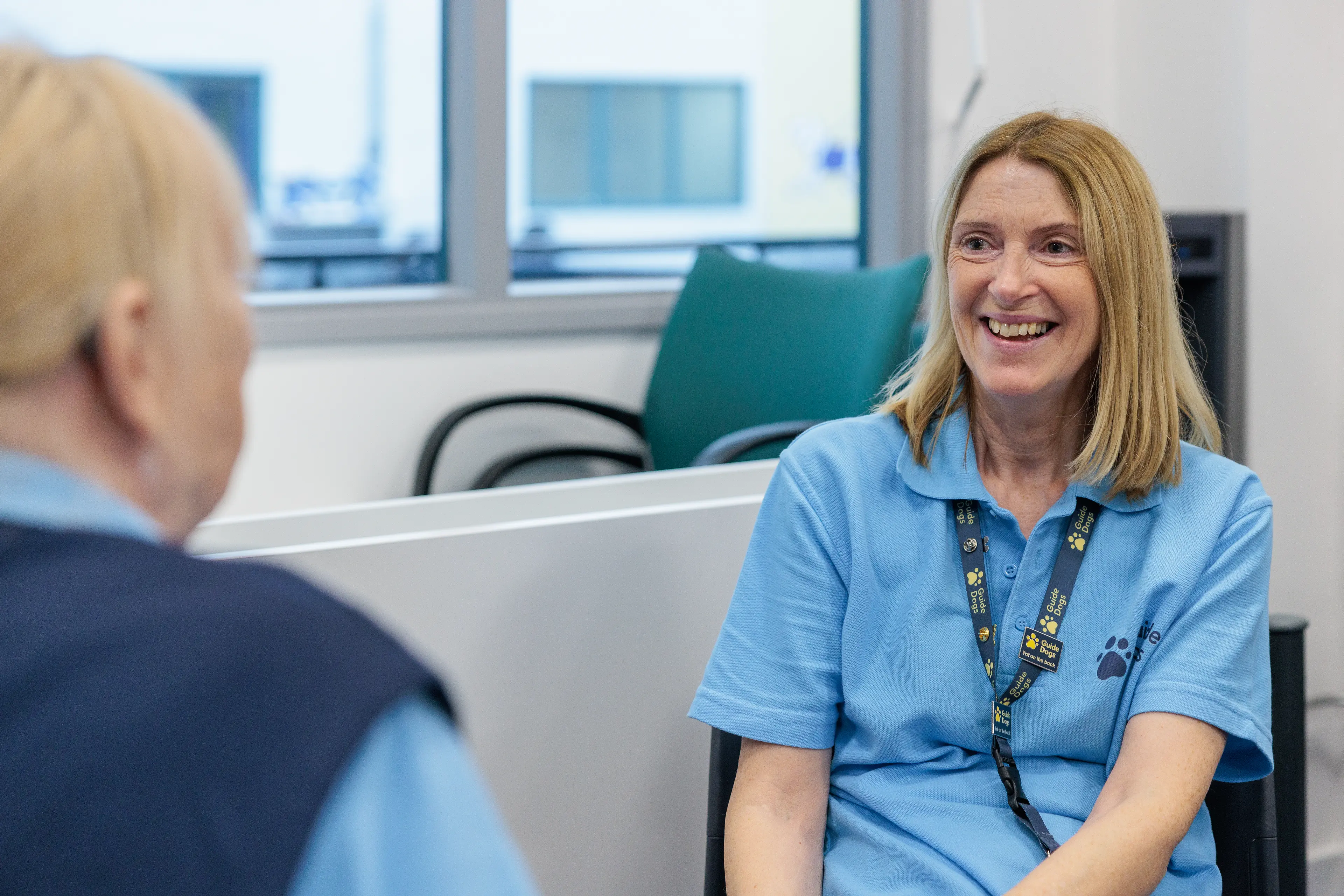 Two people sit laughing together.
