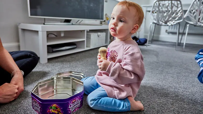 Eliza, a young service user, plays with sensory toys at home.