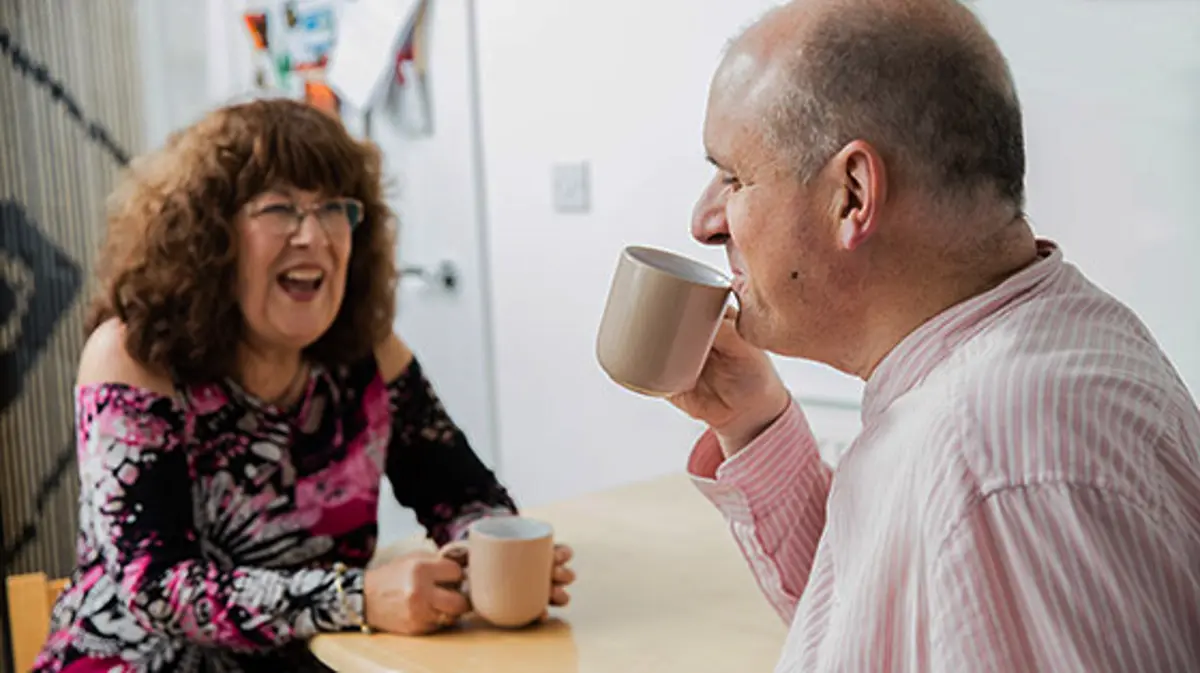 Guide dog owner John with his wife Jan drinking tea at home