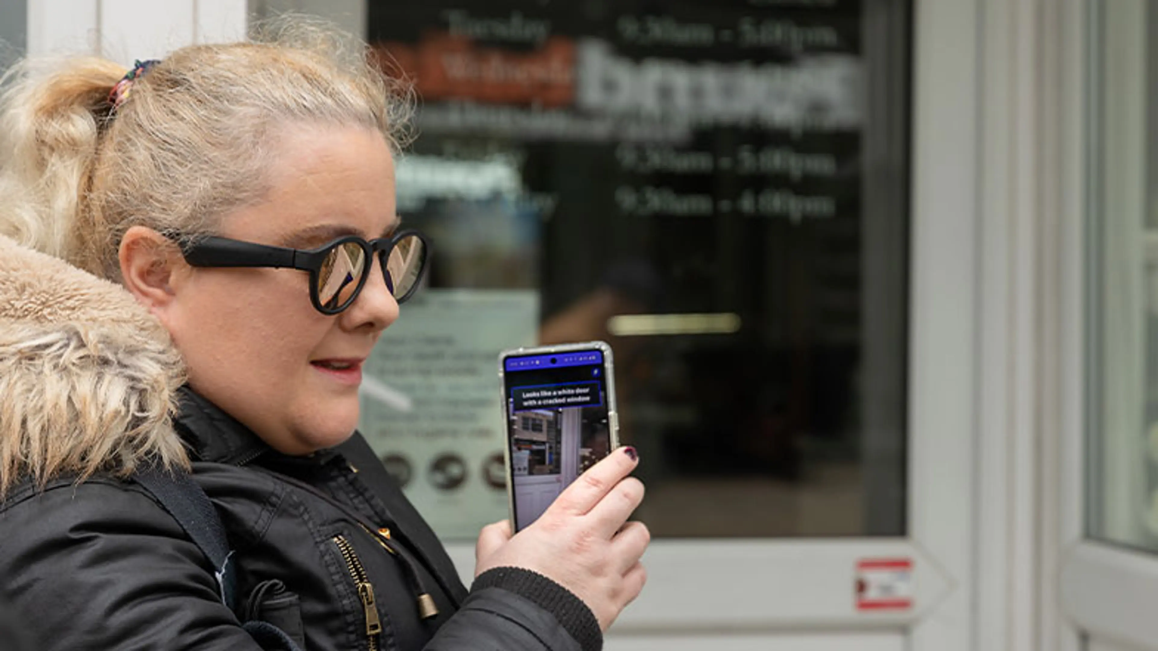 A visually impaired person using the google lookout application to identify things around her