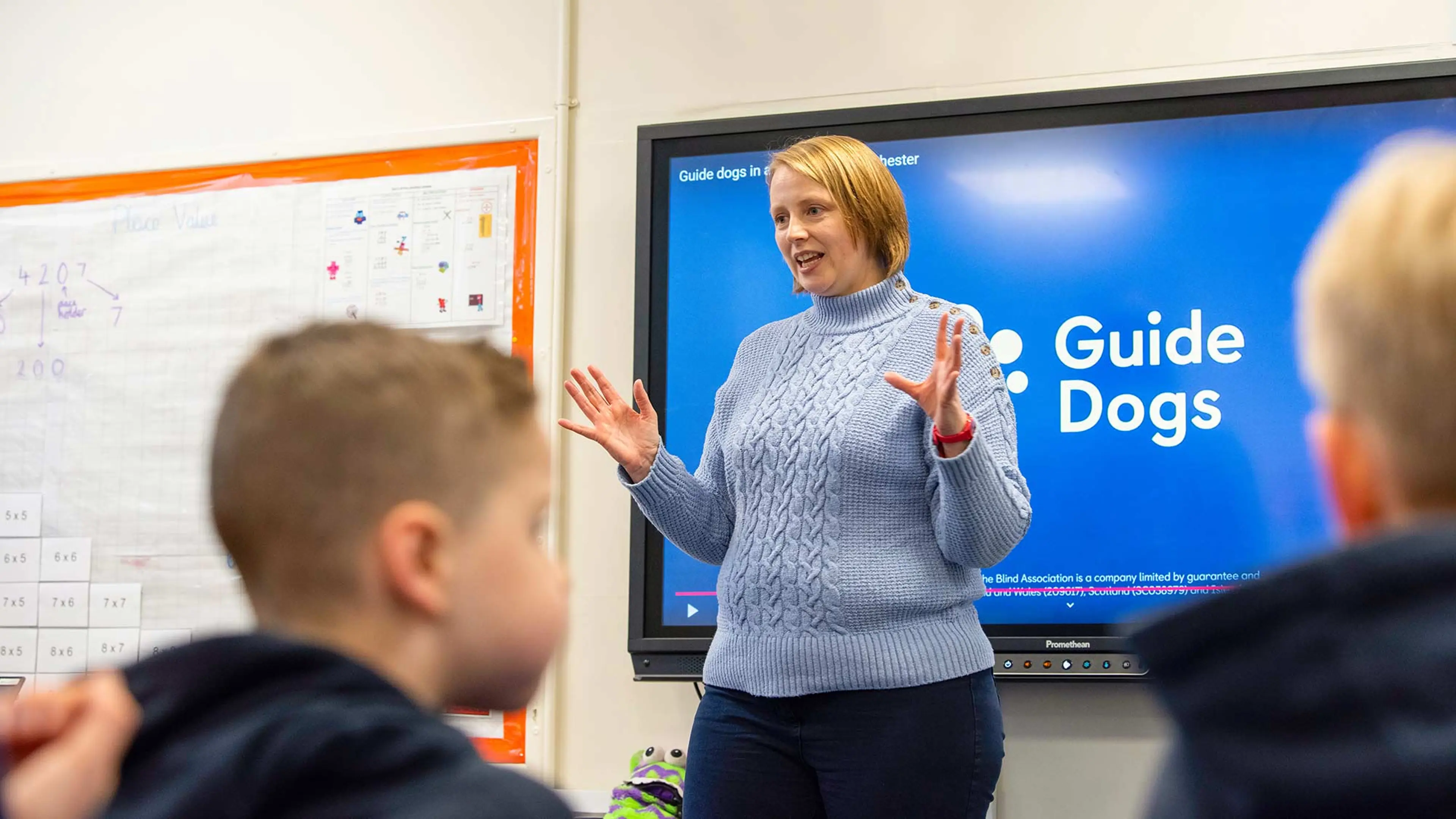 Guide Dogs sopeaker talks to school children in classroom