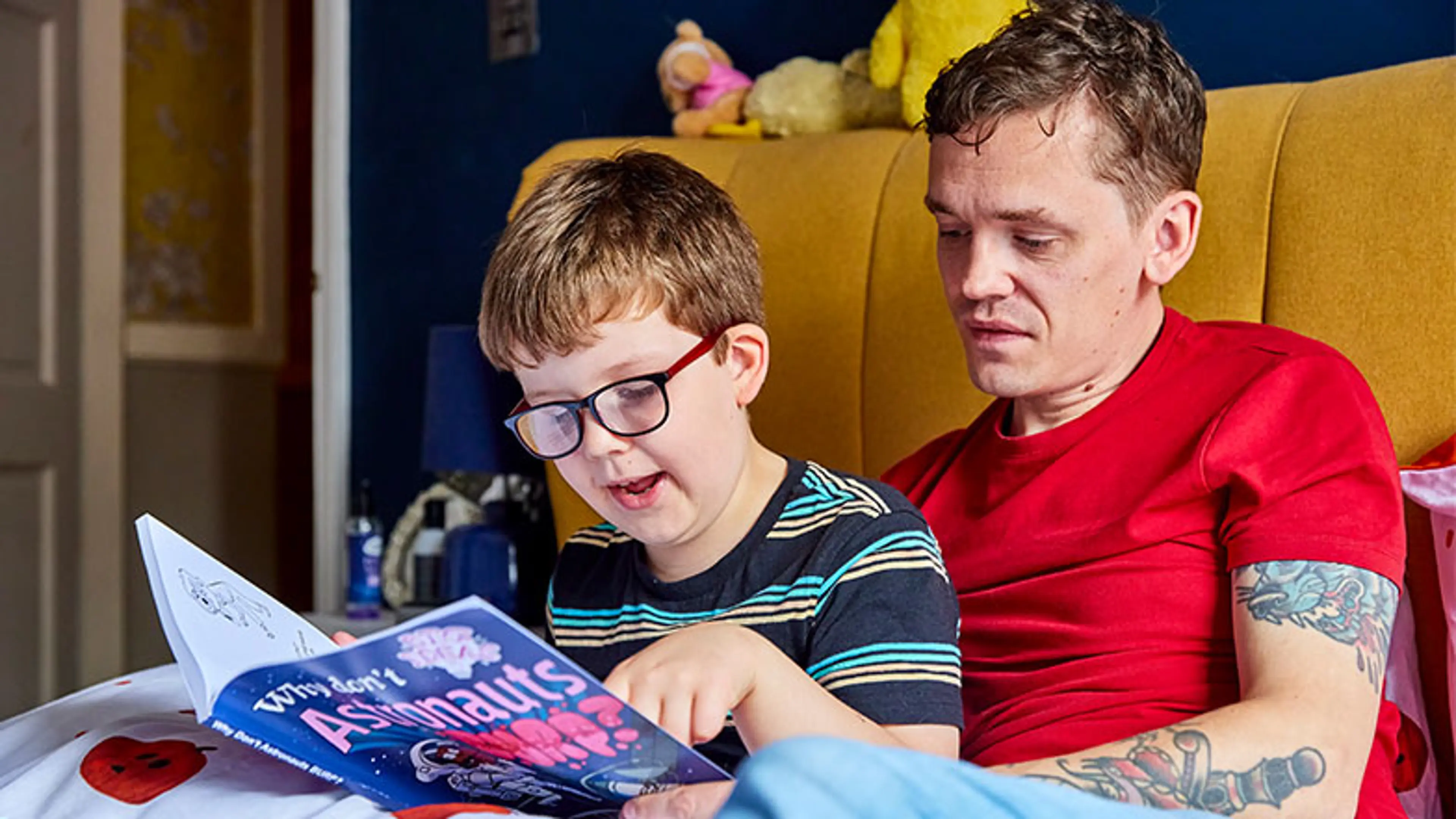 Rex reading a book about astronauts, large-print by Guide Dogs Custom Eyes books service.