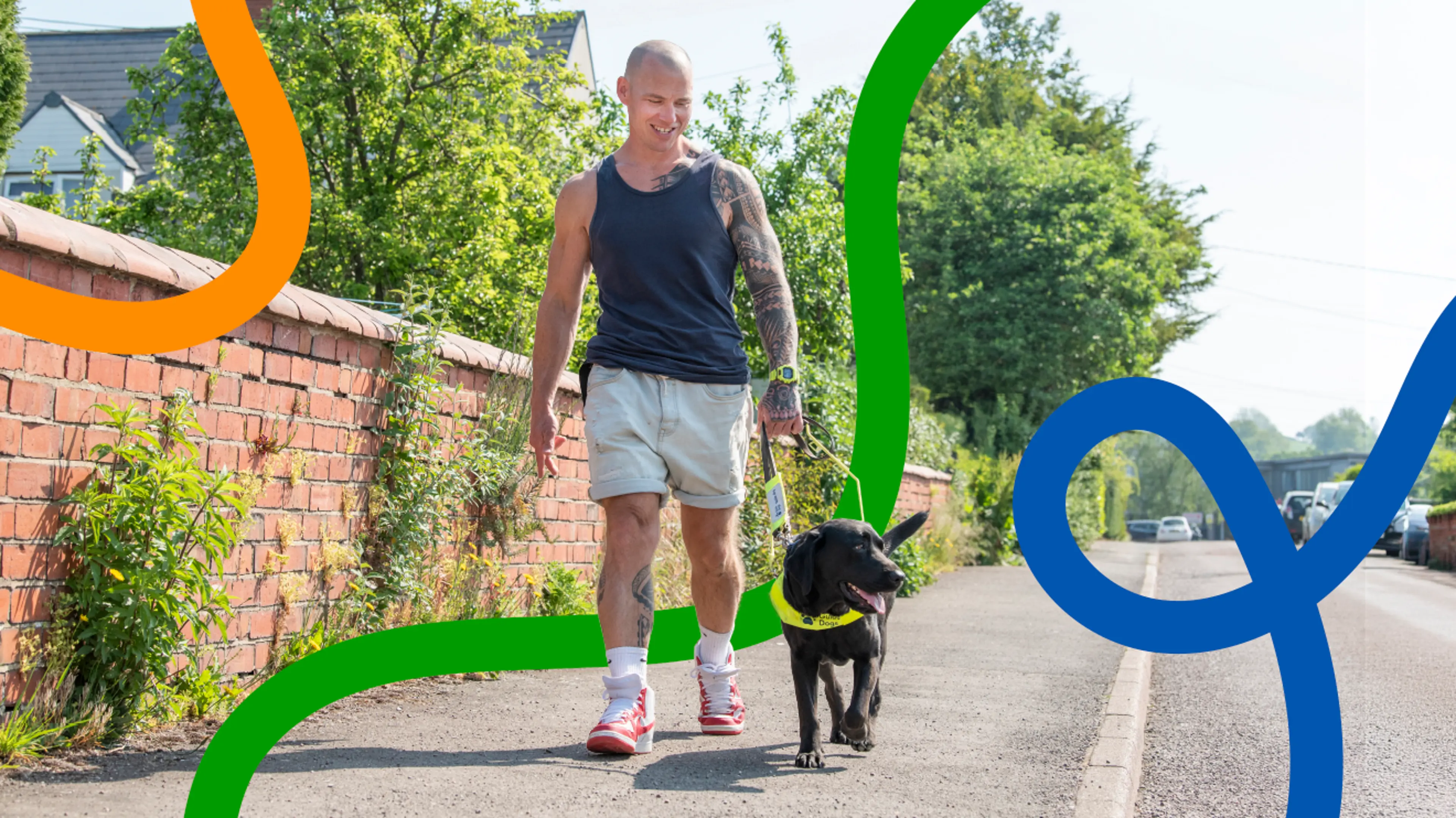 Guide dog owner Mark walks along a sunny street holding the harness of his guide dog Mary.