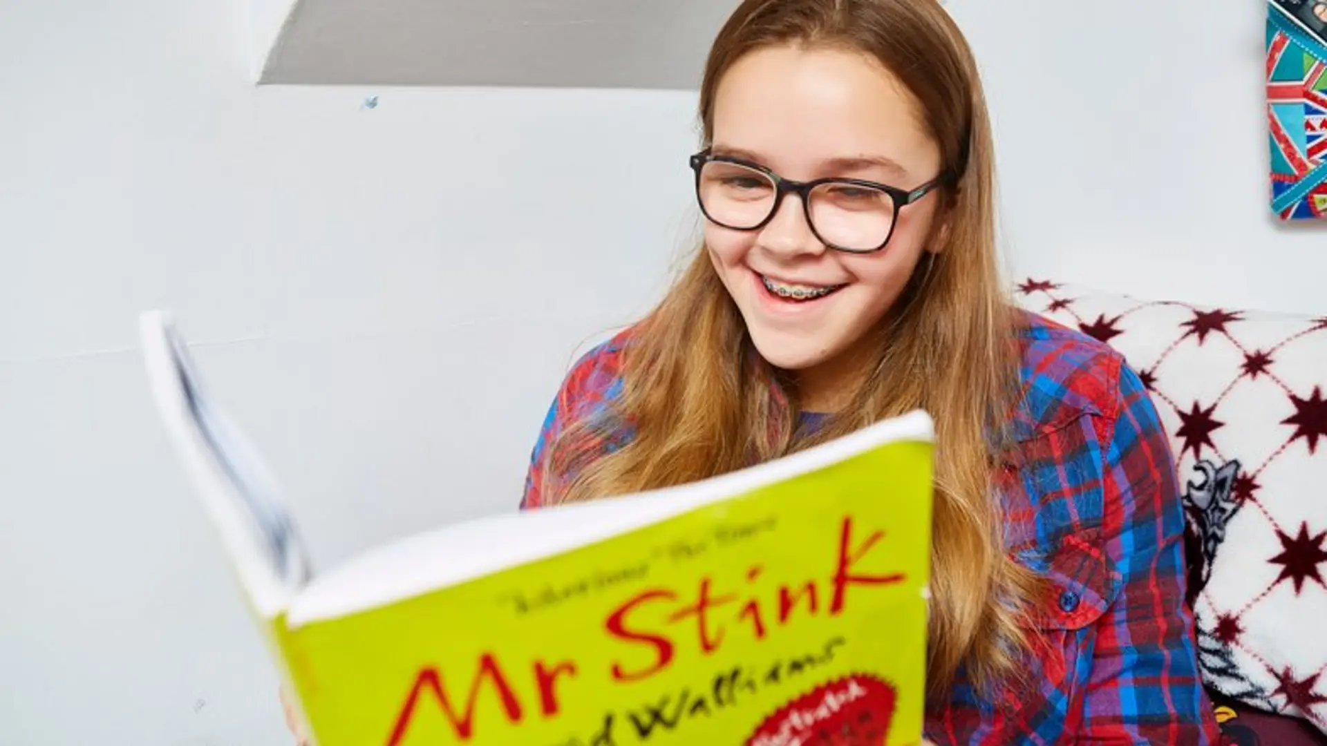 Caitlin reading Mr Stink kids book.