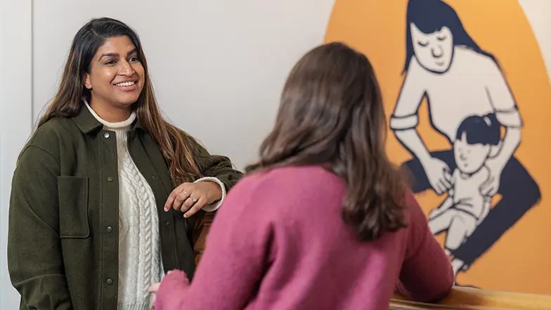 Two women smile as they talk
