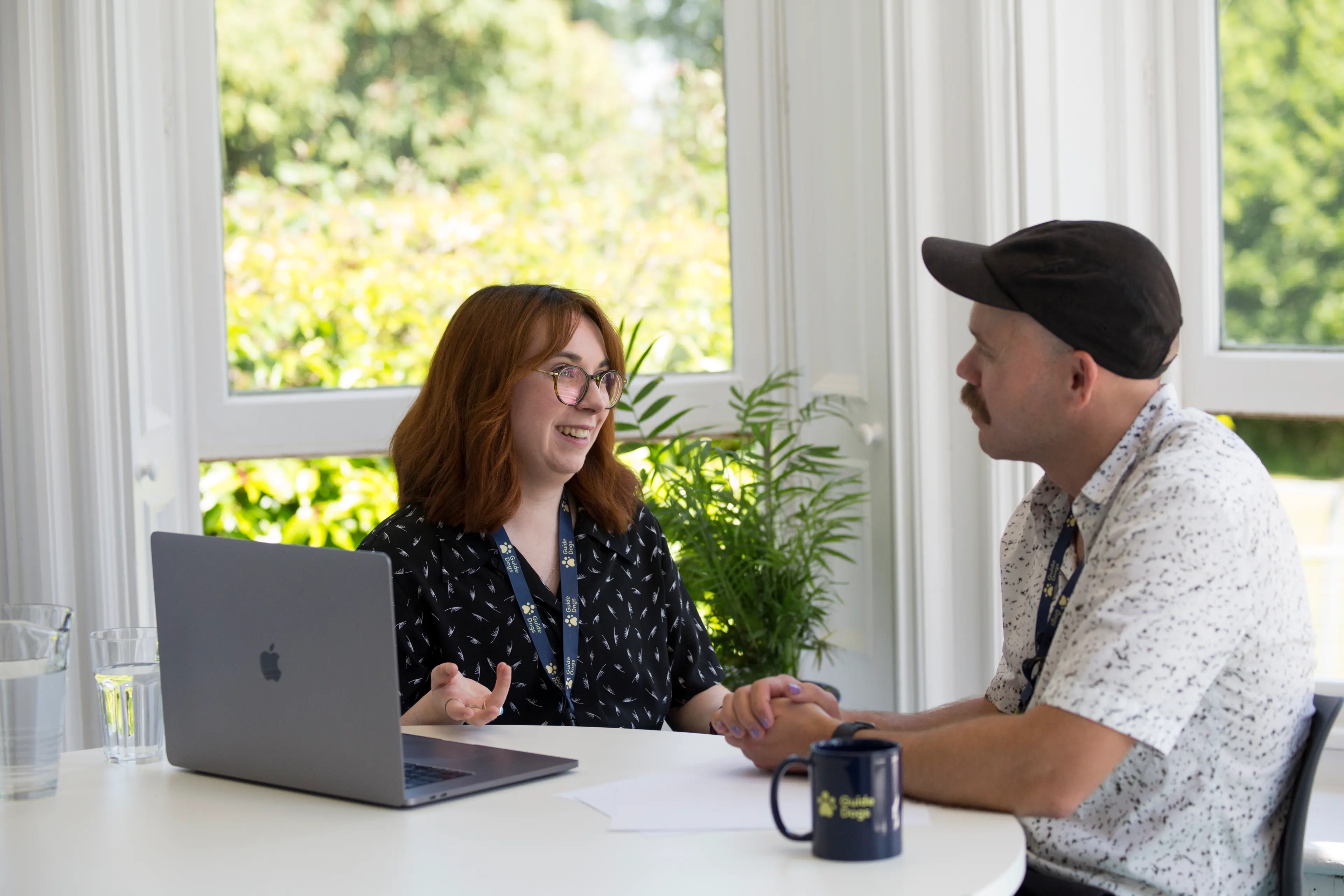Two colleagues are having a conversation in an office.