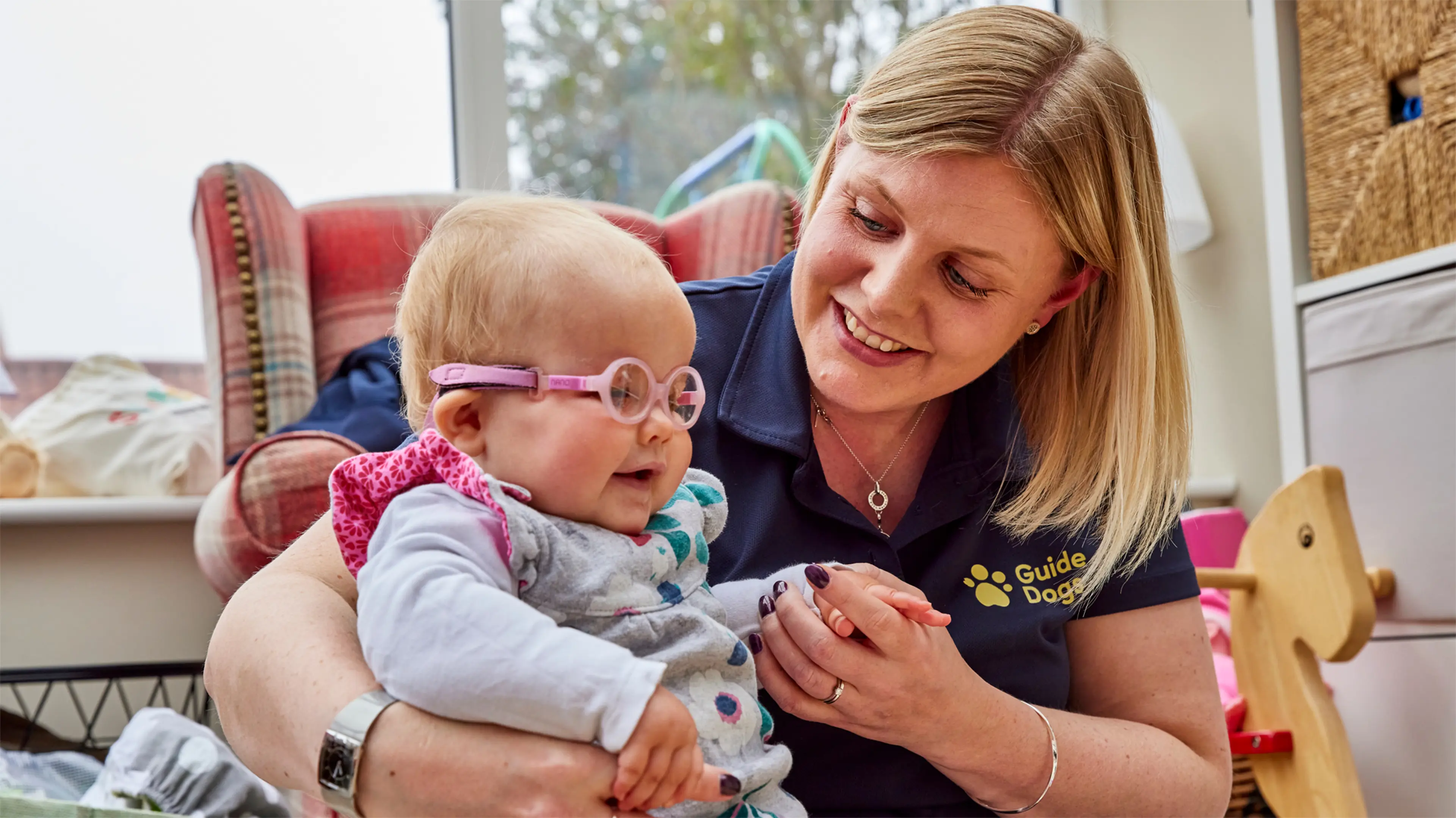Margot, a young child with vision impairment, is supported at home by her Habilitation Specialist Kate.