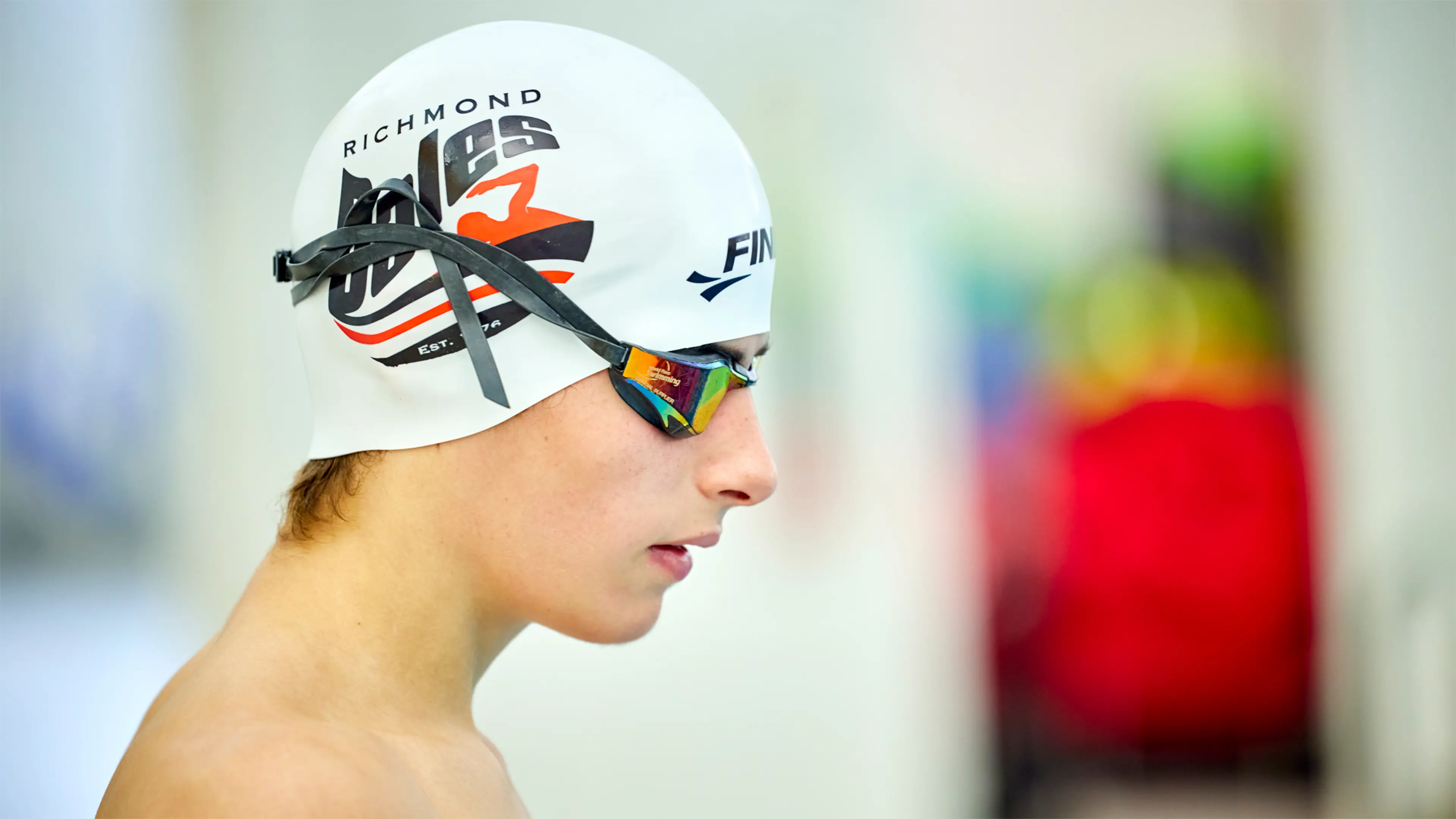 Archie, who has a vision impairment, wears a swimming cap and goggles.