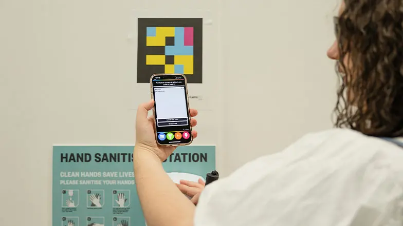 Cerys using the NaviLens app to scan a code