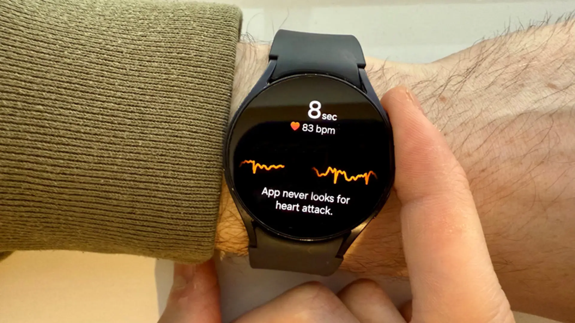 A person uses a Galaxy Watch to check their heart rate