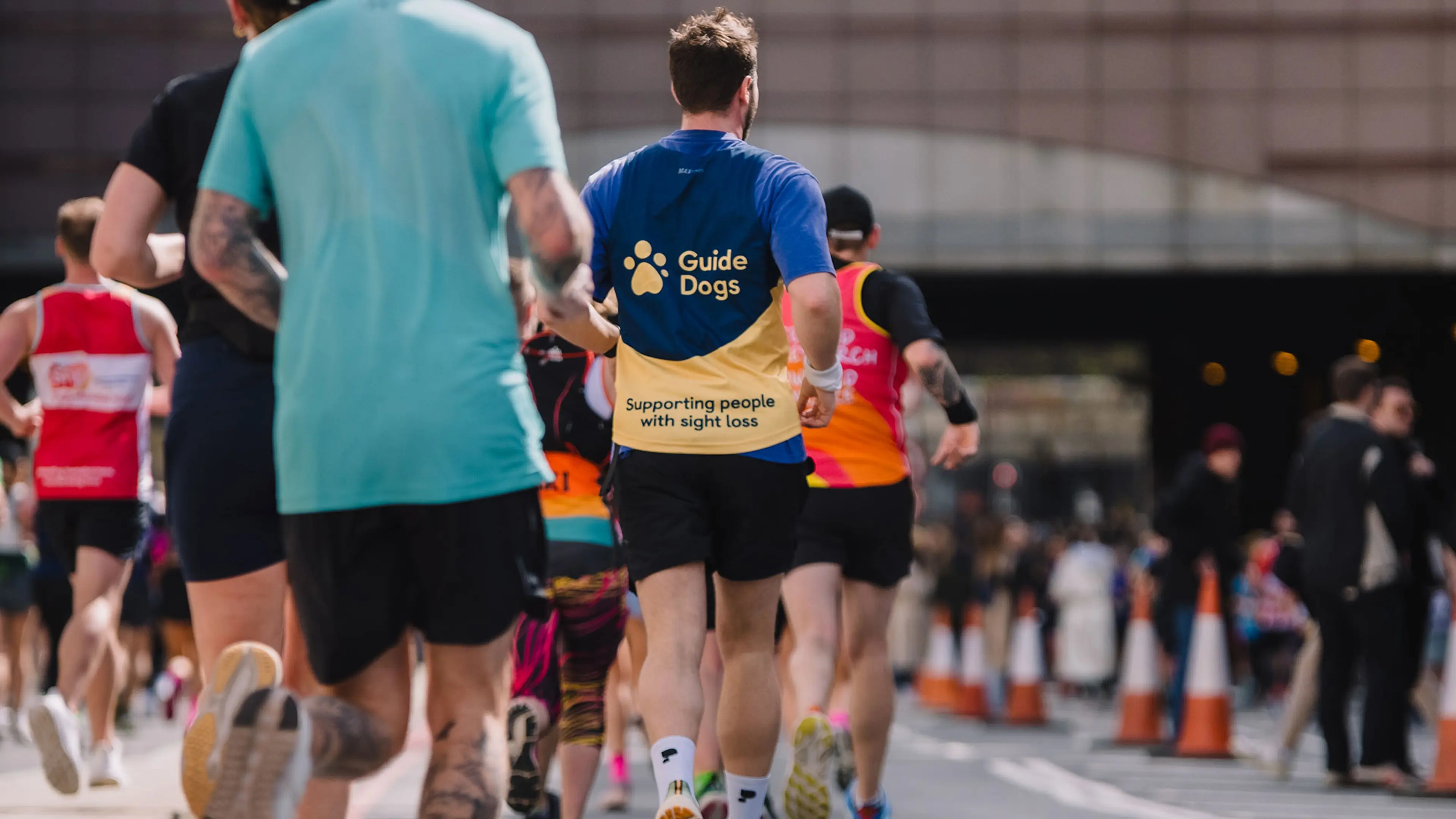 A runner in a Guide Dogs T-shirt.