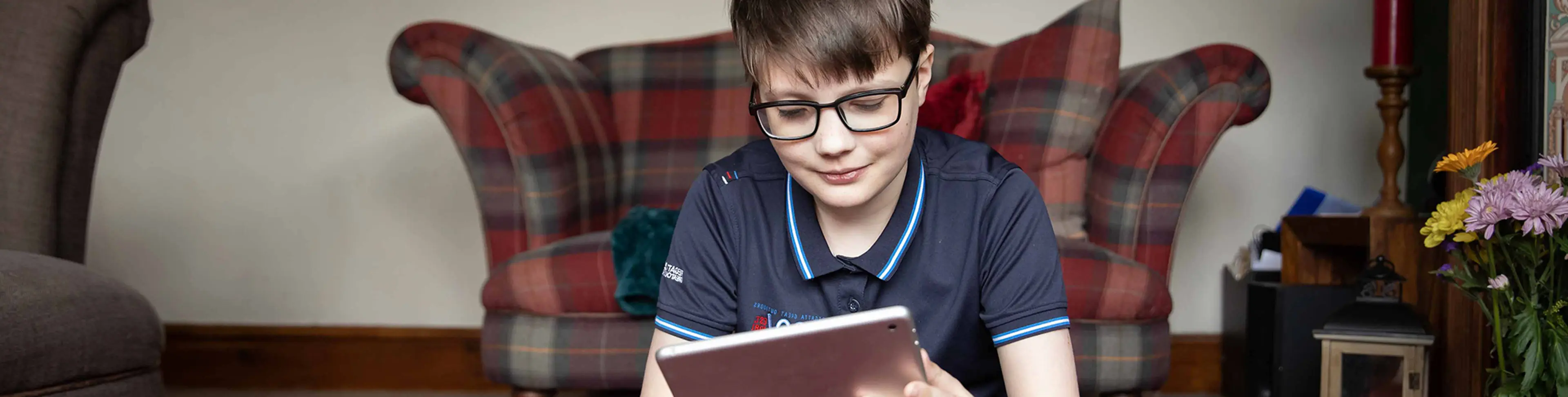 An image of Will smiling at his iPad screen