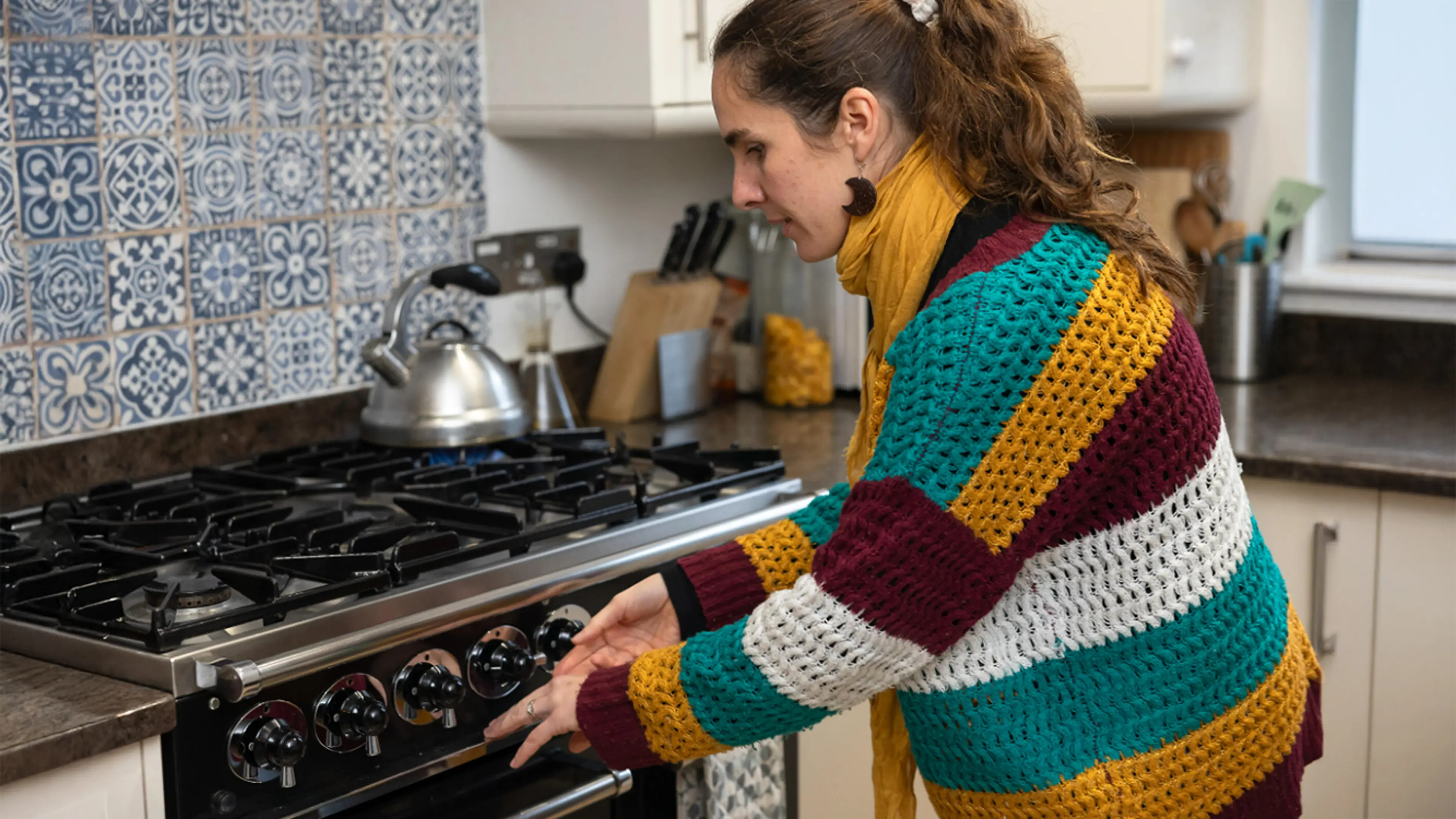 Alba, who has a vision impairment, shows how she boils a pod of tea at home with the use of tactile labels