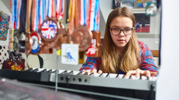 Caitlin playing a keyboard