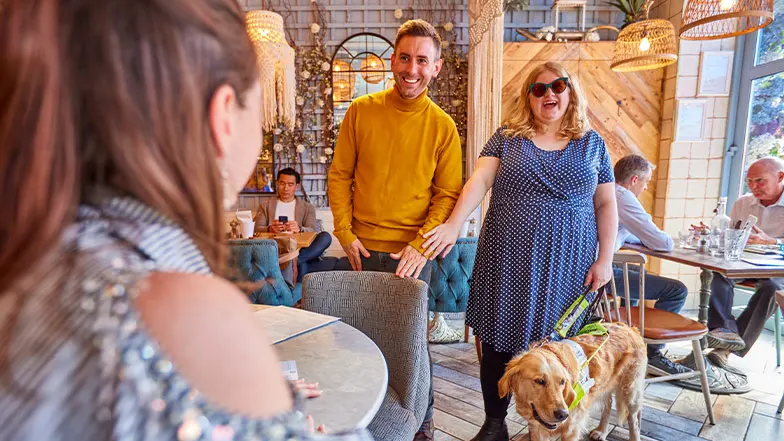 Friends meeting up for lunch with a guide dog owner