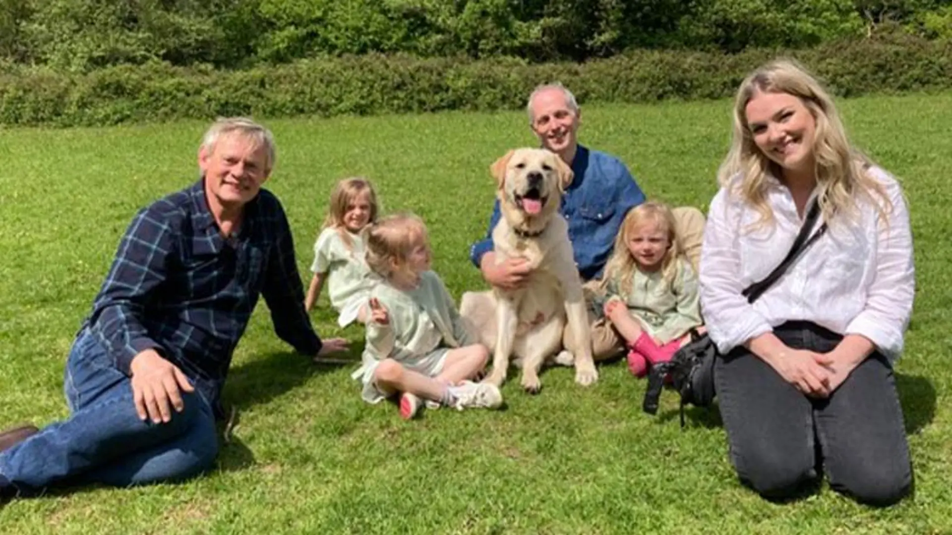 The Vanstone family sit with Martin in the sunshine.