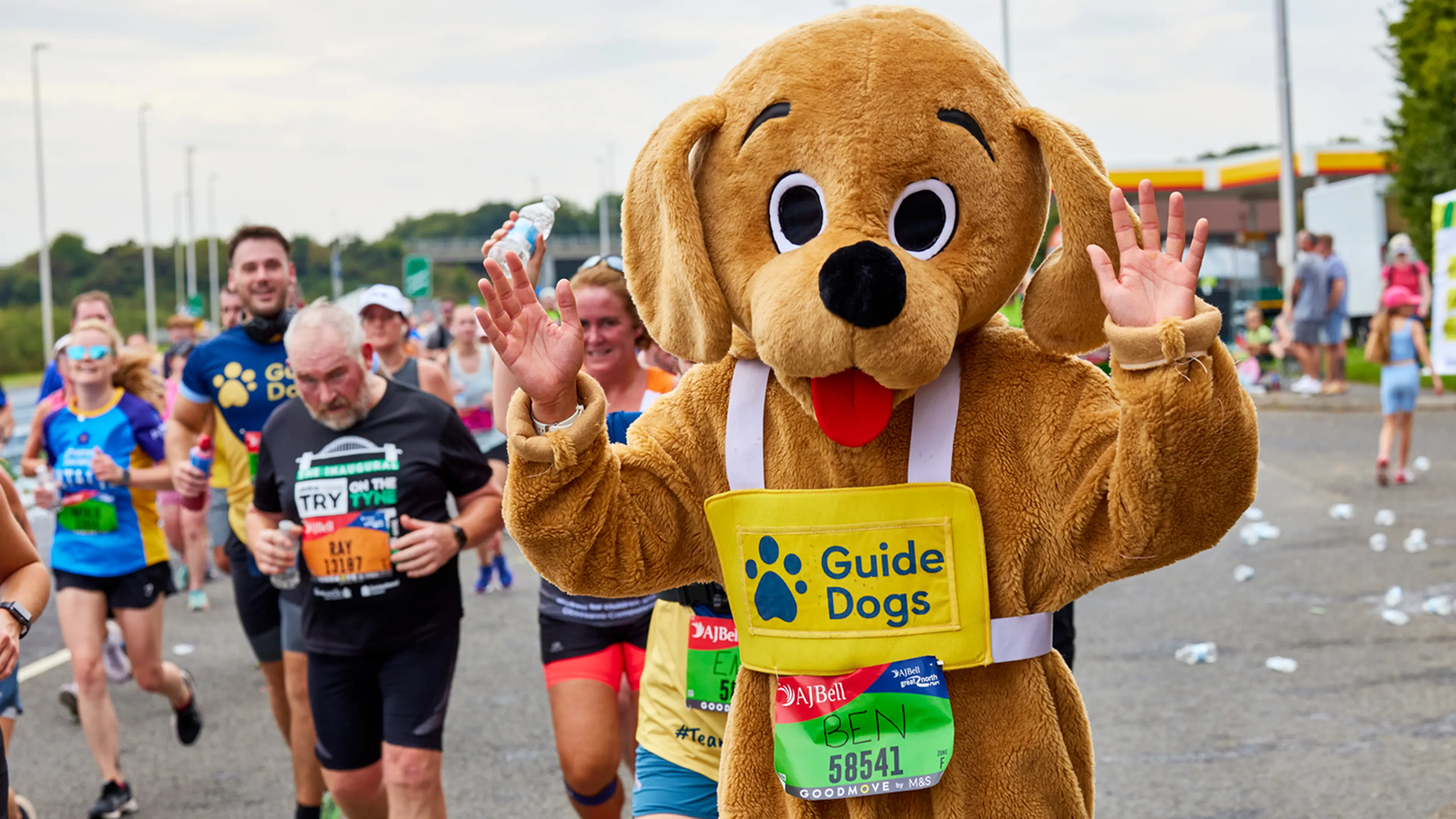 A man dressed in a dog suit takes part in the Great North Run for Guide Dogs. 
