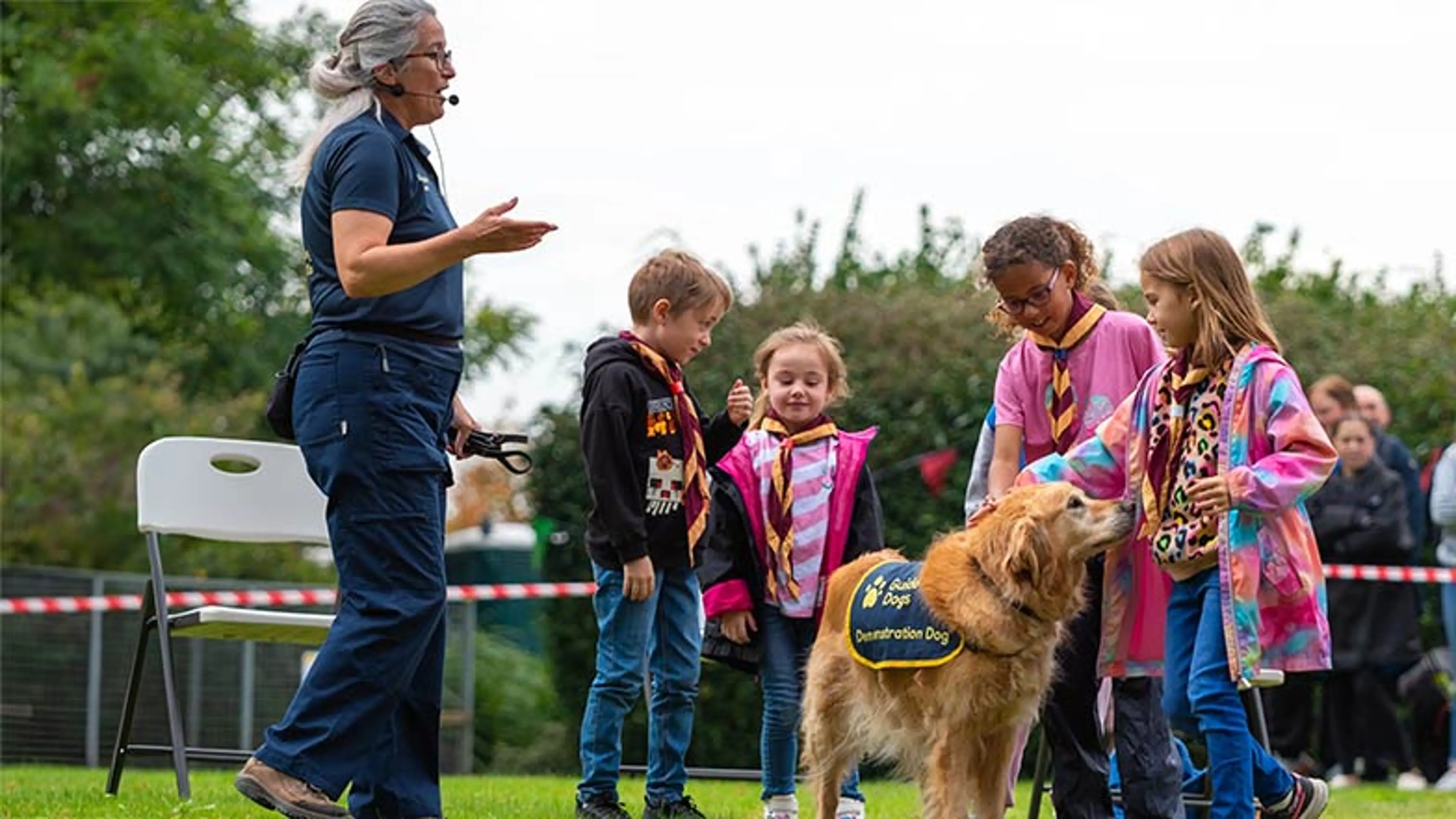 Guide Dogs demonstration dog and speaker with youth group children.