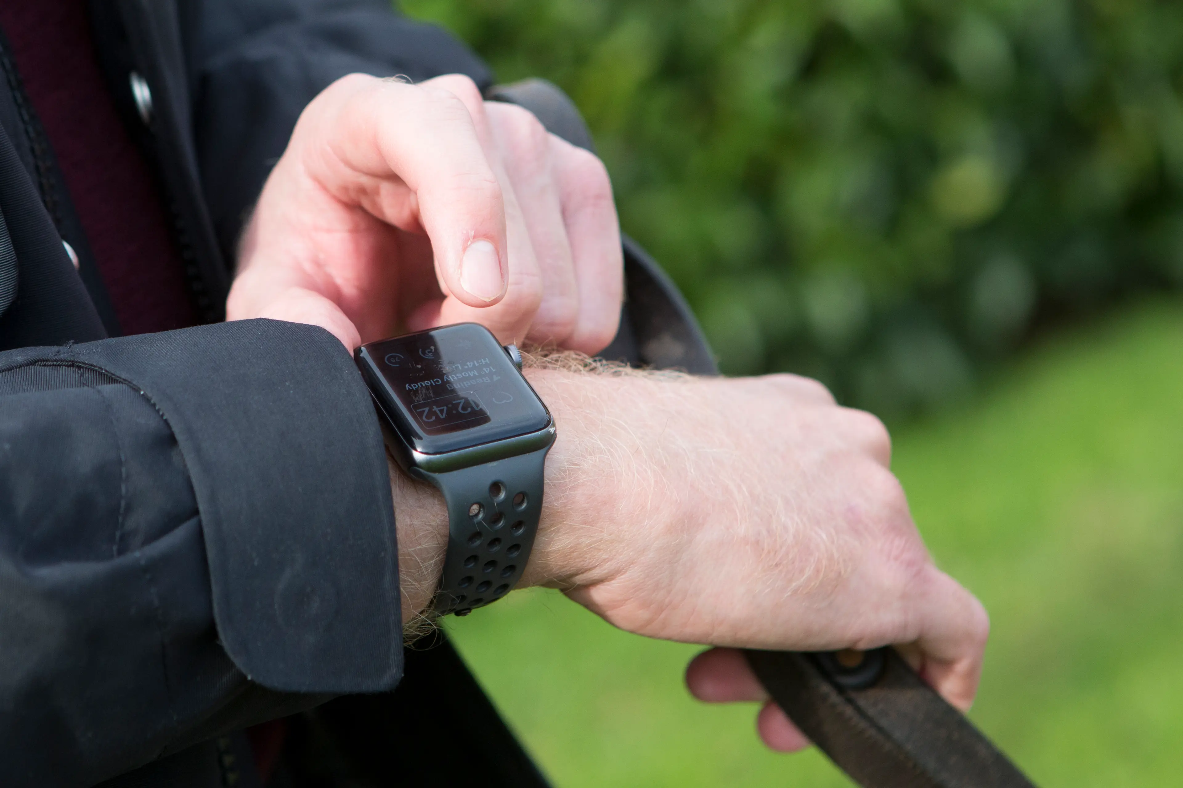 A Guide Dog owner operates his Apple Watch.