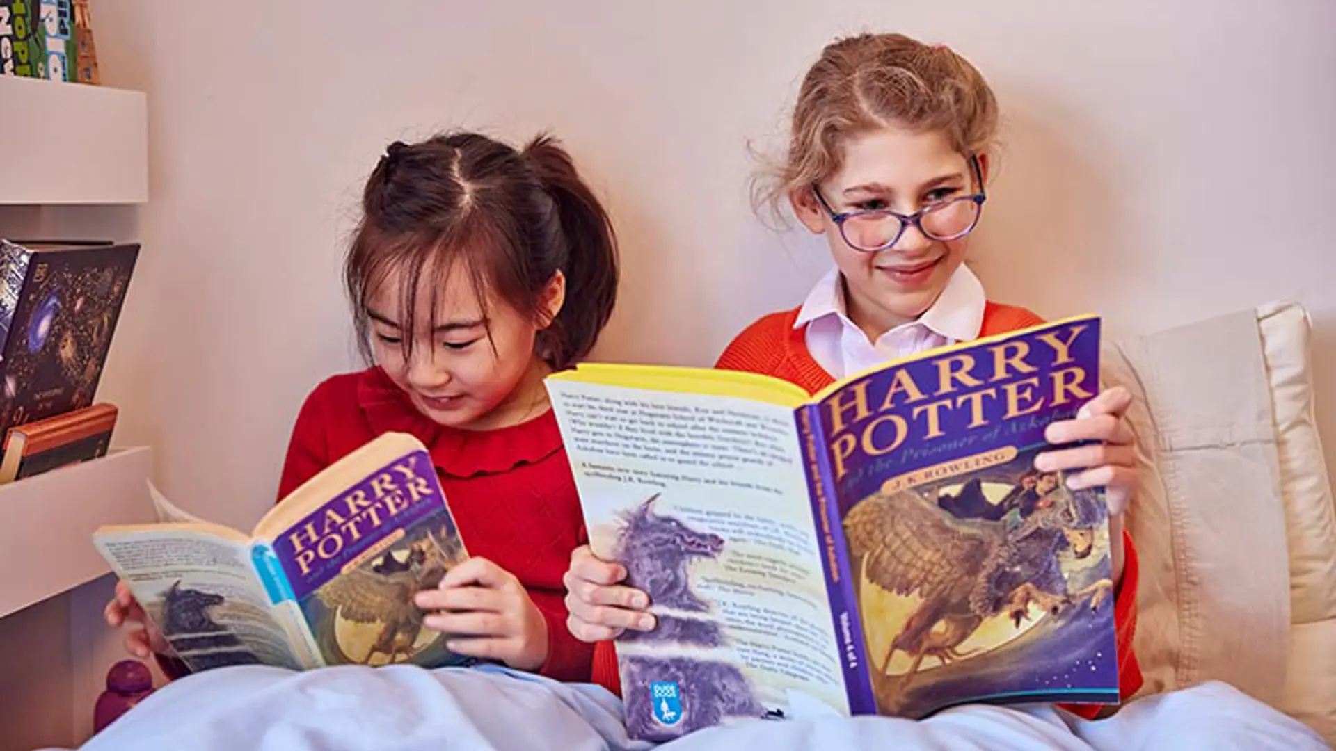 Two school children reading Harry Potter, one is reading a CustomEyes version of the book.