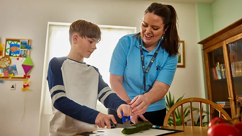 Ralph and his Habilitation Specialist are in the kitchen preparing a meal.